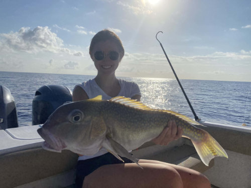 Young woman holding a large fish