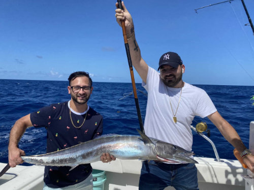 two men holding a large fish