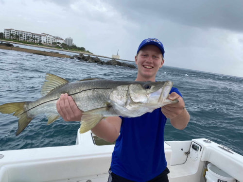 young boy holding a fish