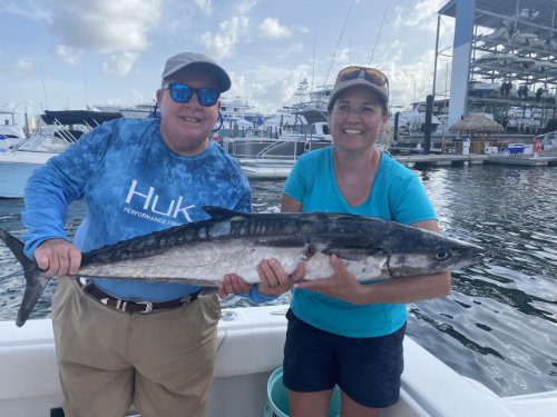 Two people holding a fish